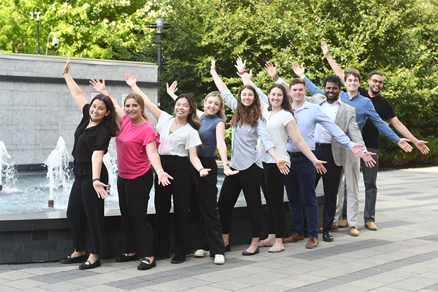 All hands-on team spirit by the water fountain