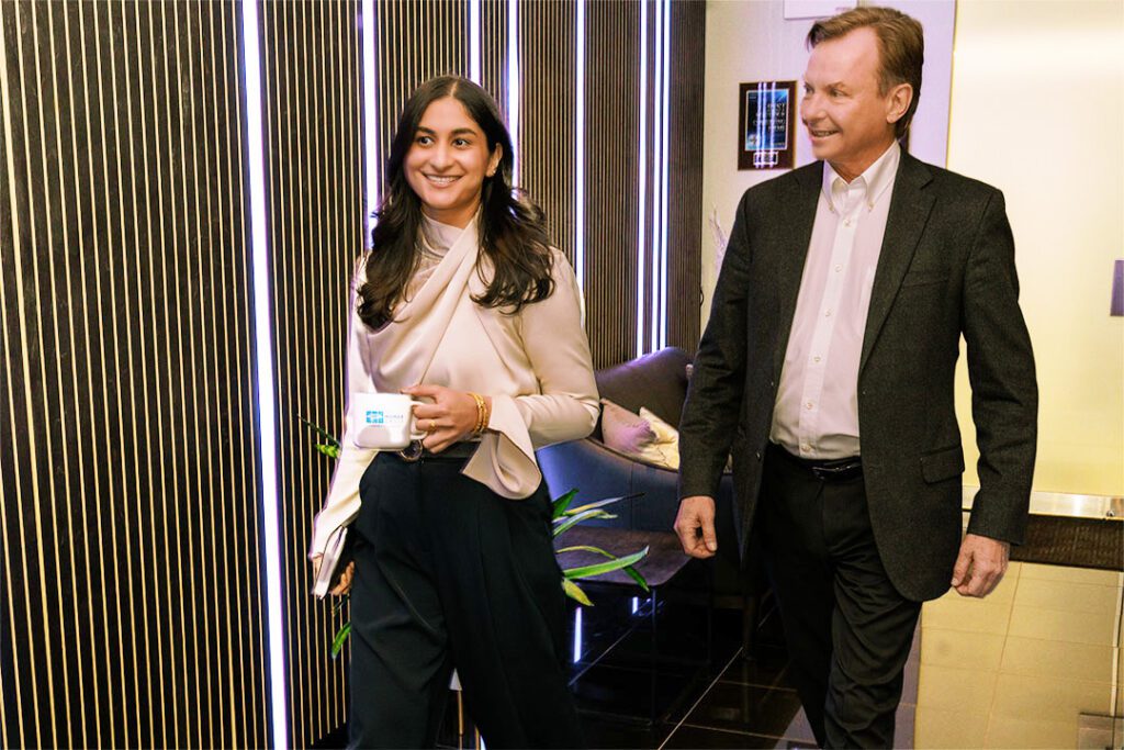 CEO David Poirier and colleague talking at the workplace